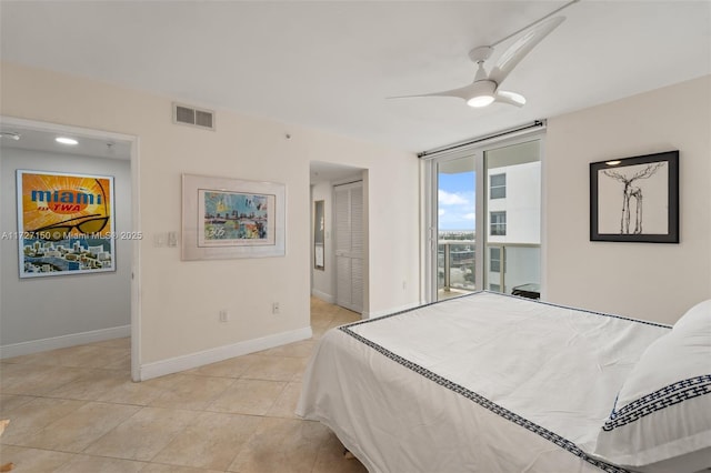 bedroom featuring floor to ceiling windows, access to exterior, a closet, ceiling fan, and light tile patterned floors