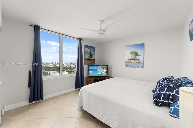 bedroom featuring ceiling fan and tile patterned flooring