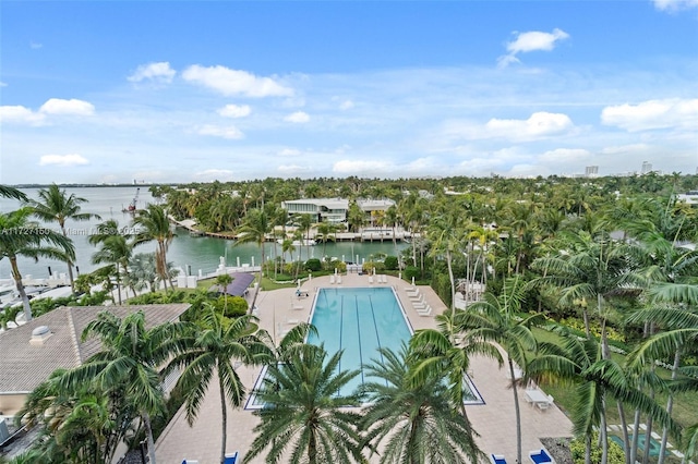 view of pool with a patio area and a water view