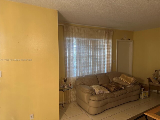 living room with light tile patterned floors and a textured ceiling