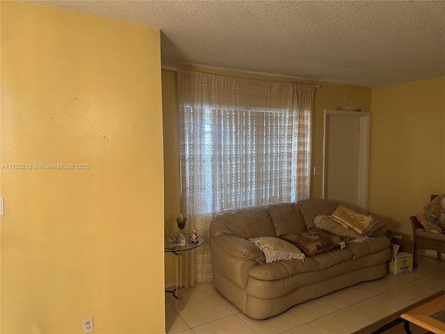 living room with light tile patterned flooring and a textured ceiling