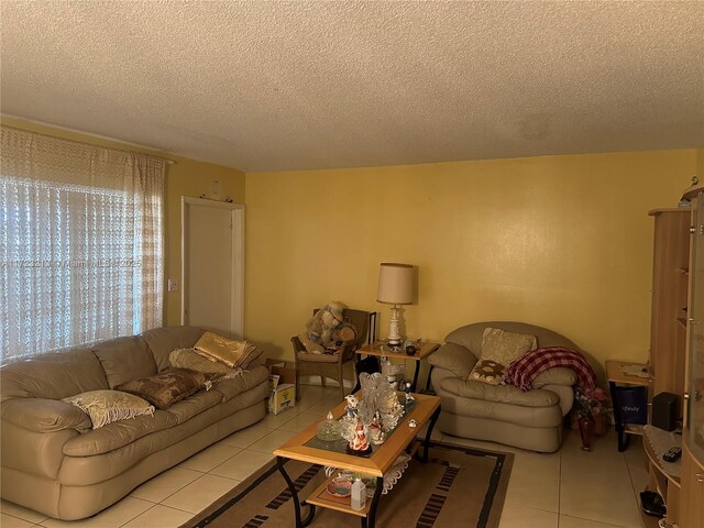 living room with light tile patterned floors and a textured ceiling