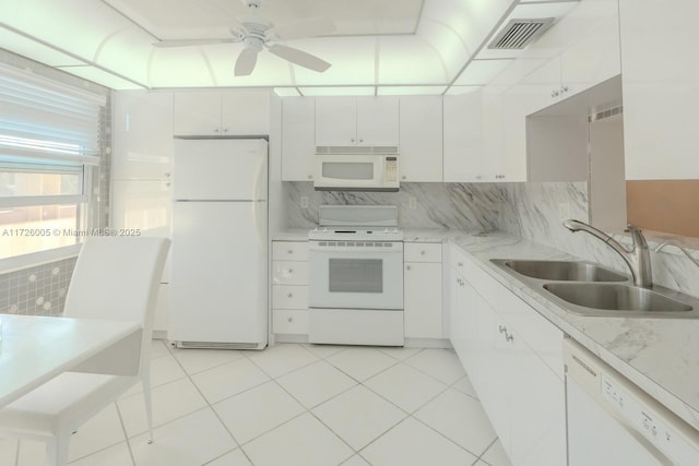 kitchen featuring ceiling fan, backsplash, white appliances, white cabinets, and sink