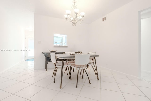 tiled dining space with a chandelier