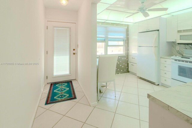 tiled dining space with a notable chandelier