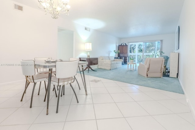 dining room featuring an inviting chandelier and light tile patterned floors