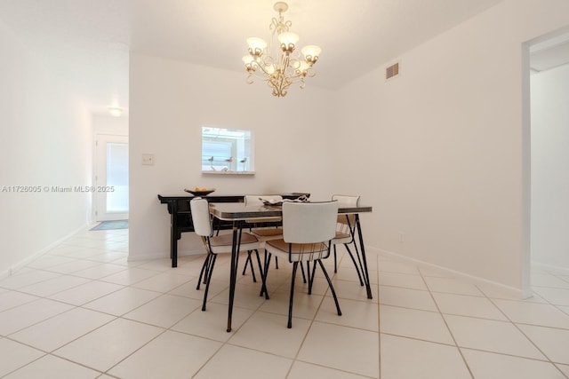 dining space with light tile patterned floors and a notable chandelier