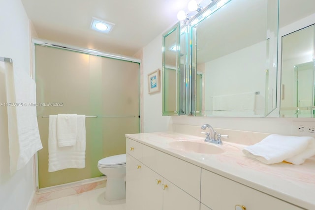 bathroom with tile patterned flooring, vanity, an enclosed shower, and toilet