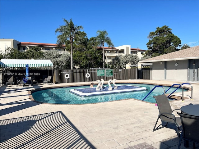 view of pool featuring a patio area and a hot tub