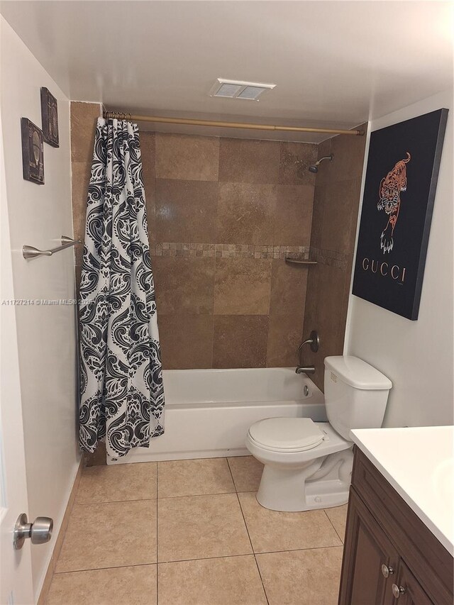 bathroom featuring toilet, walk in shower, vanity, and tile patterned flooring