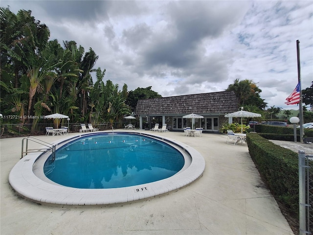 pool featuring a patio area and fence