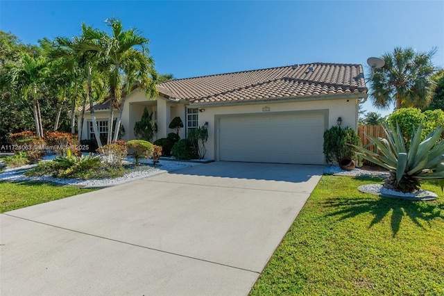 mediterranean / spanish-style home with a garage and a front yard