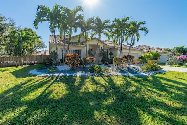 view of front of property with a front lawn and a garage