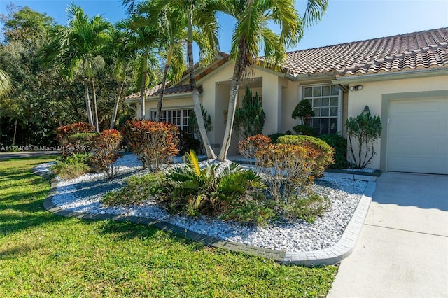 view of side of property featuring a garage and a yard