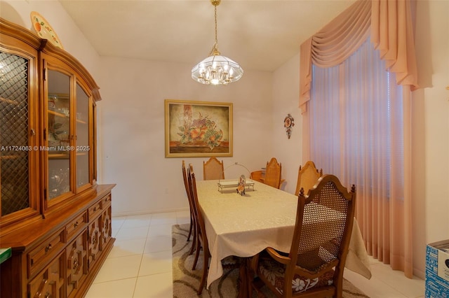 tiled dining space with an inviting chandelier