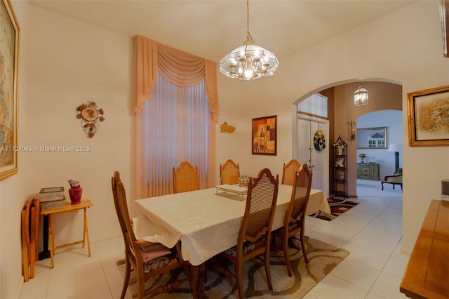 tiled dining area with an inviting chandelier