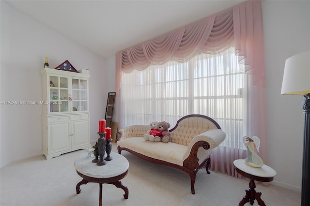 living area with light colored carpet and lofted ceiling