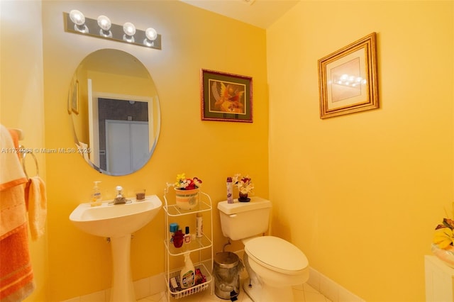 bathroom featuring toilet and tile patterned flooring