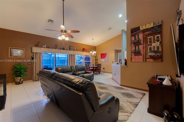 tiled living room with high vaulted ceiling and ceiling fan with notable chandelier