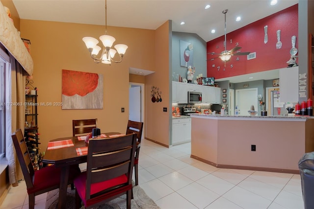 kitchen featuring tasteful backsplash, white cabinetry, high vaulted ceiling, light tile patterned floors, and ceiling fan with notable chandelier