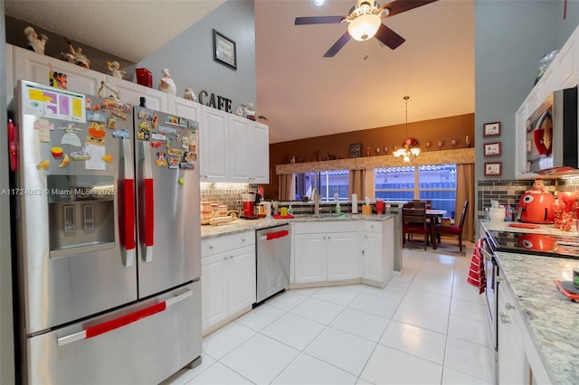 kitchen with decorative backsplash, white cabinetry, hanging light fixtures, appliances with stainless steel finishes, and ceiling fan with notable chandelier