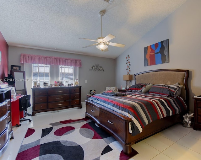 bedroom featuring ceiling fan, a textured ceiling, and vaulted ceiling