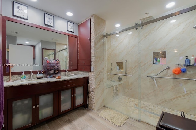 bathroom featuring vanity, a shower with door, and hardwood / wood-style flooring