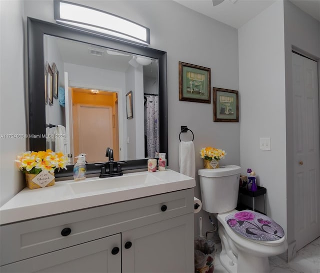 bathroom with toilet and vanity