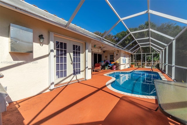 view of pool with a patio area, a lanai, and french doors