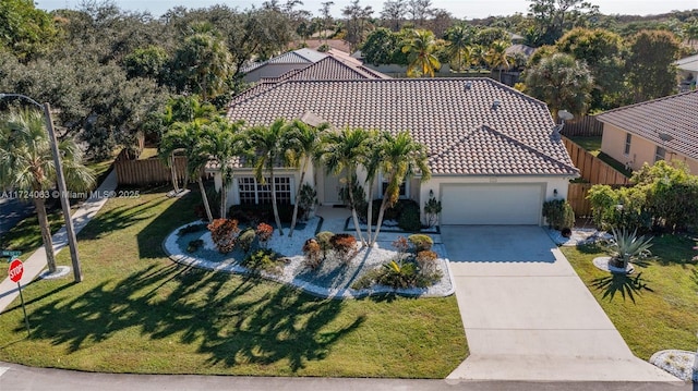 mediterranean / spanish home with a garage and a front yard