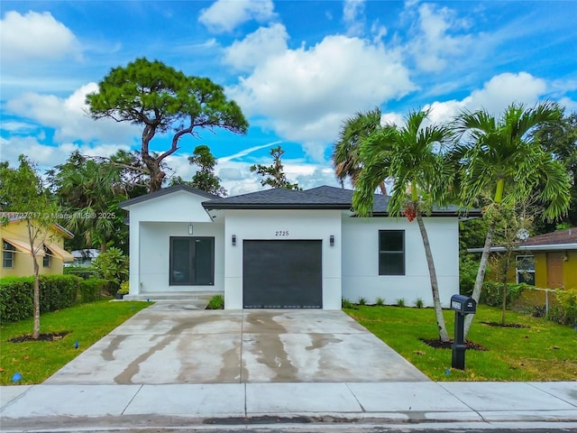 view of front facade with a shingled roof, a front lawn, stucco siding, a garage, and driveway