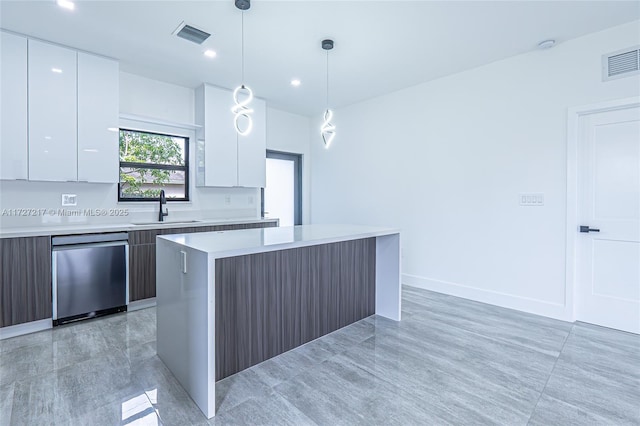 kitchen featuring visible vents, a sink, light countertops, modern cabinets, and stainless steel dishwasher