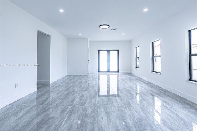 spare room with recessed lighting, visible vents, and baseboards