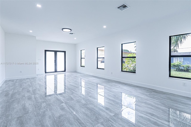 empty room featuring visible vents, recessed lighting, french doors, and baseboards