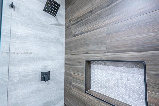 interior details with a tile shower