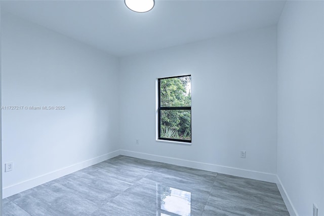 empty room featuring baseboards