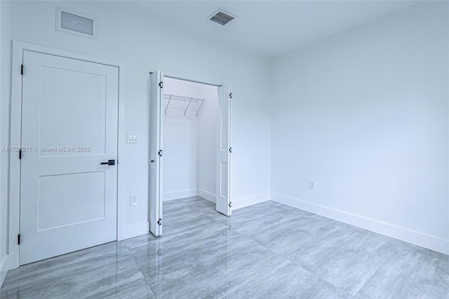 unfurnished bedroom featuring visible vents, baseboards, and a closet