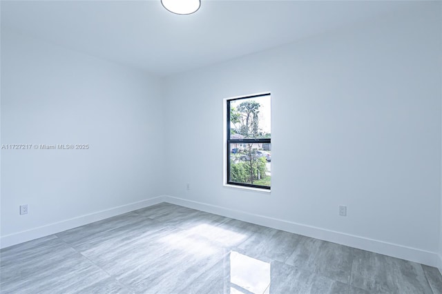 unfurnished room featuring baseboards