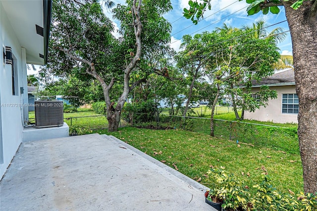 view of yard featuring a patio, a fenced backyard, and central AC