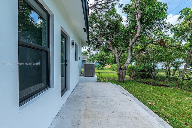 view of patio / terrace featuring cooling unit and fence