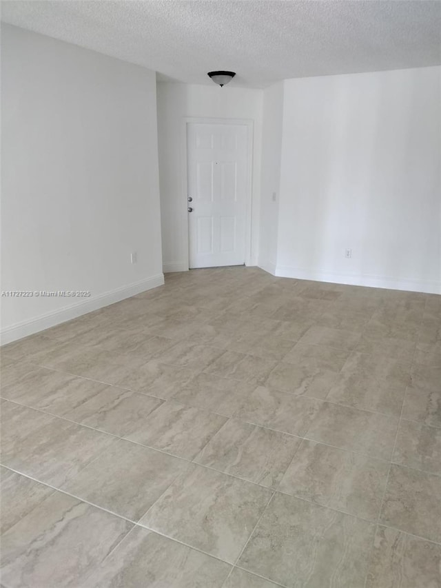 empty room featuring a textured ceiling