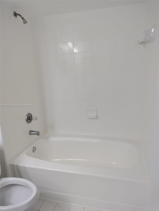 bathroom with toilet, tile patterned flooring, and tub / shower combination