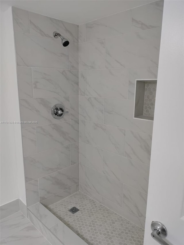 bathroom with tiled shower