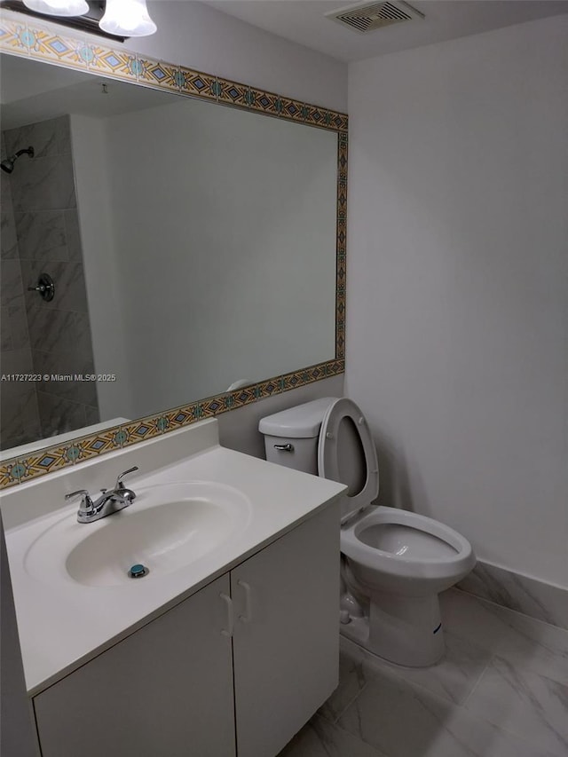 bathroom with toilet and vanity