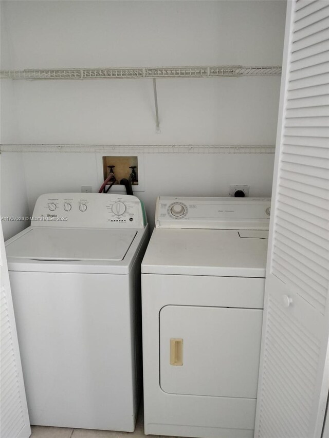 laundry room featuring washing machine and clothes dryer