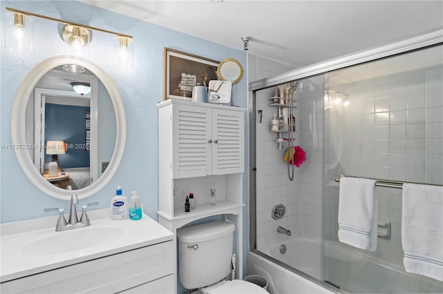 bathroom with enclosed tub / shower combo, toilet, and vanity
