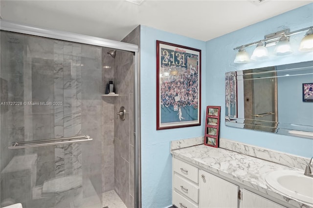 bathroom with an enclosed shower and vanity