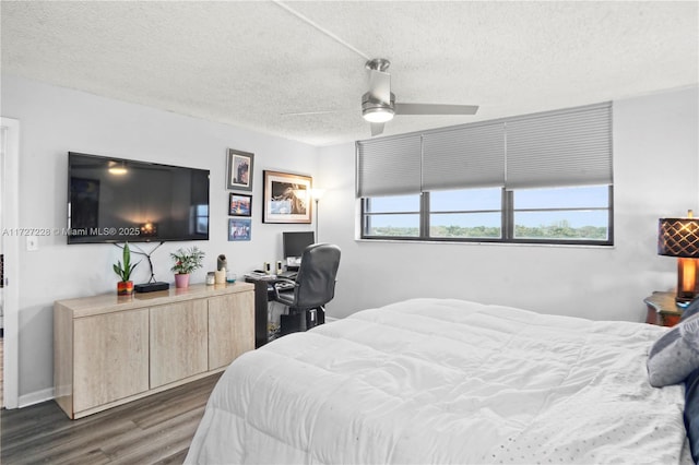 bedroom featuring ceiling fan, dark hardwood / wood-style floors, and a textured ceiling