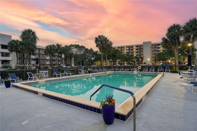 pool at dusk with a patio