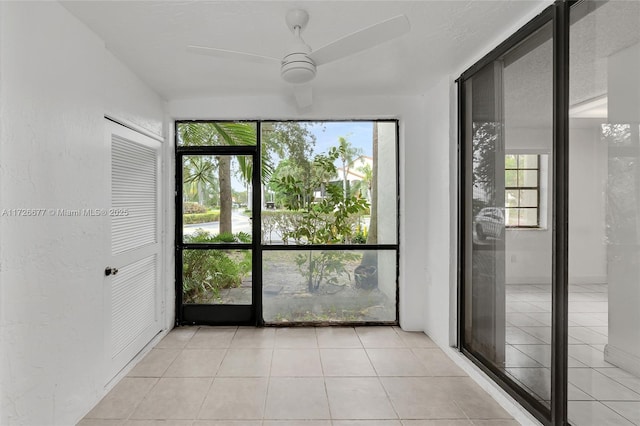 interior space with ceiling fan